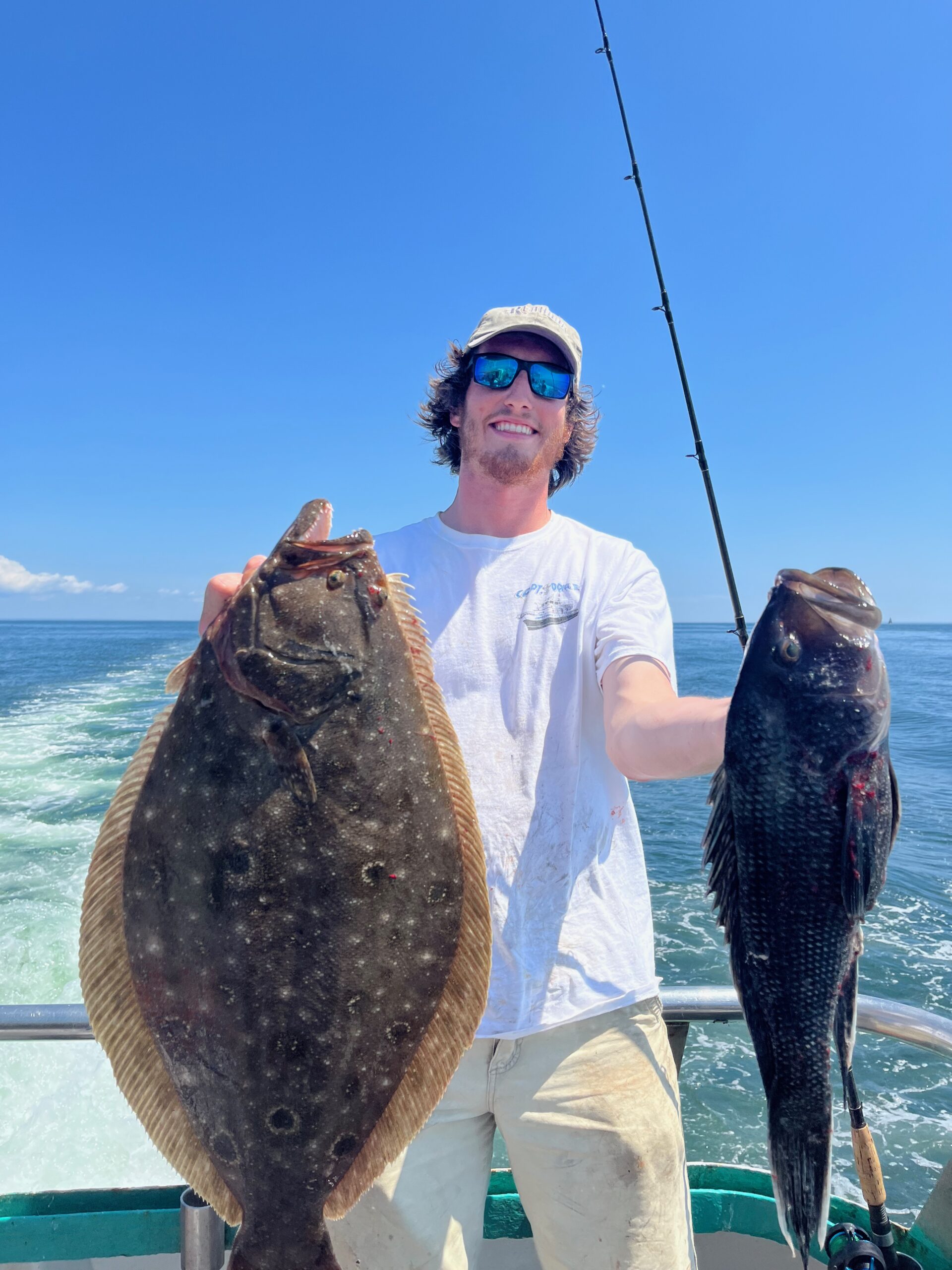 a man holding a fish in the water