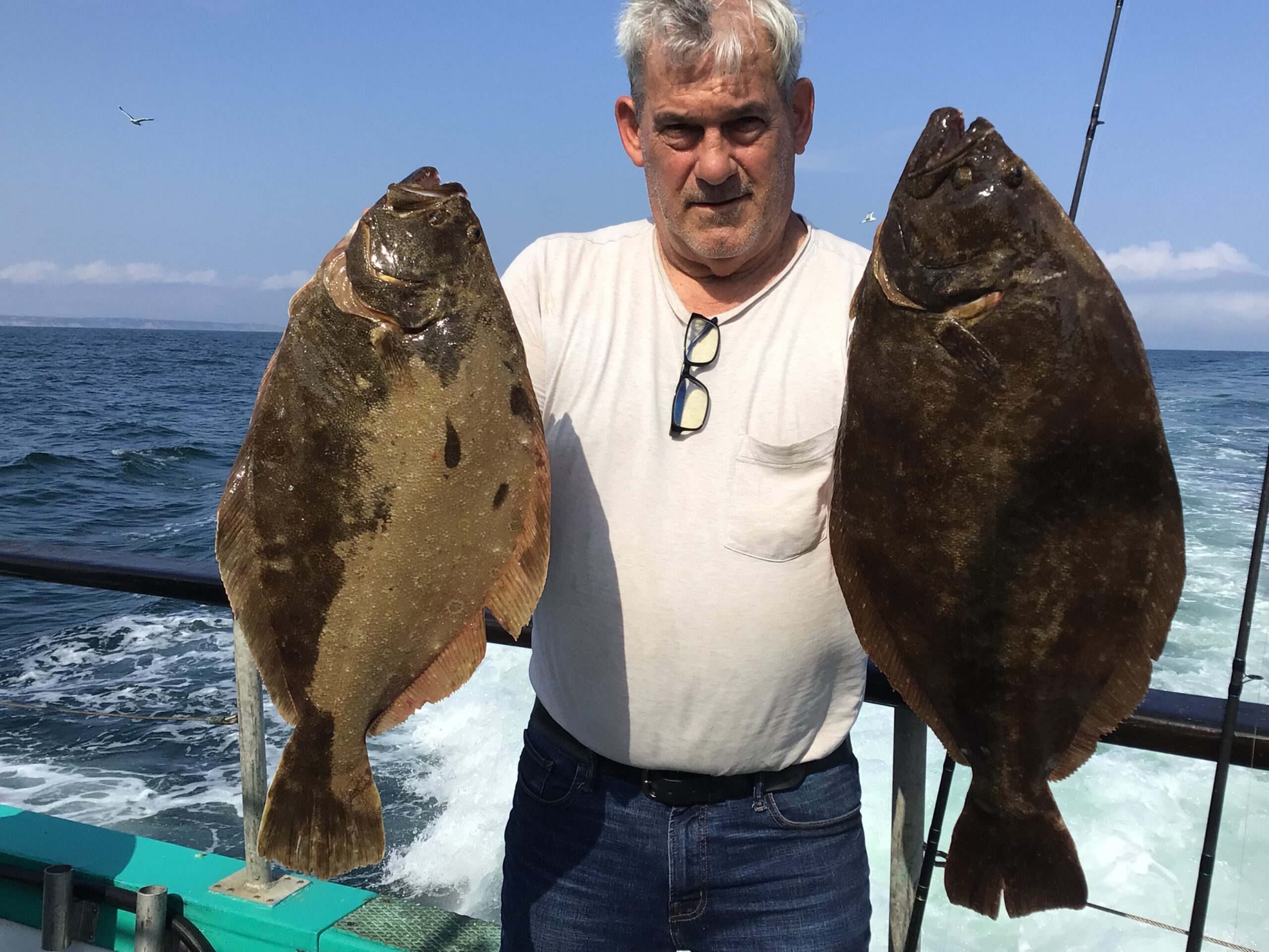 a man holding a fish in the water