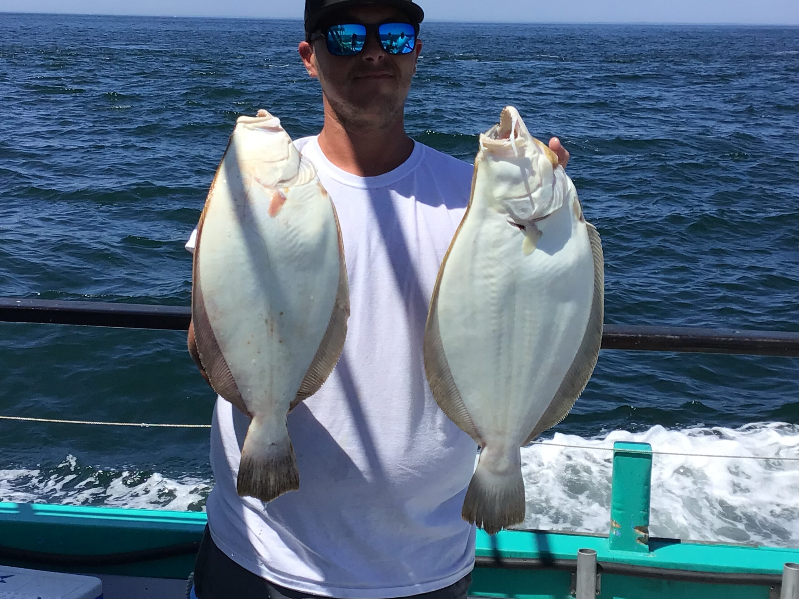 a man holding a fish in the water