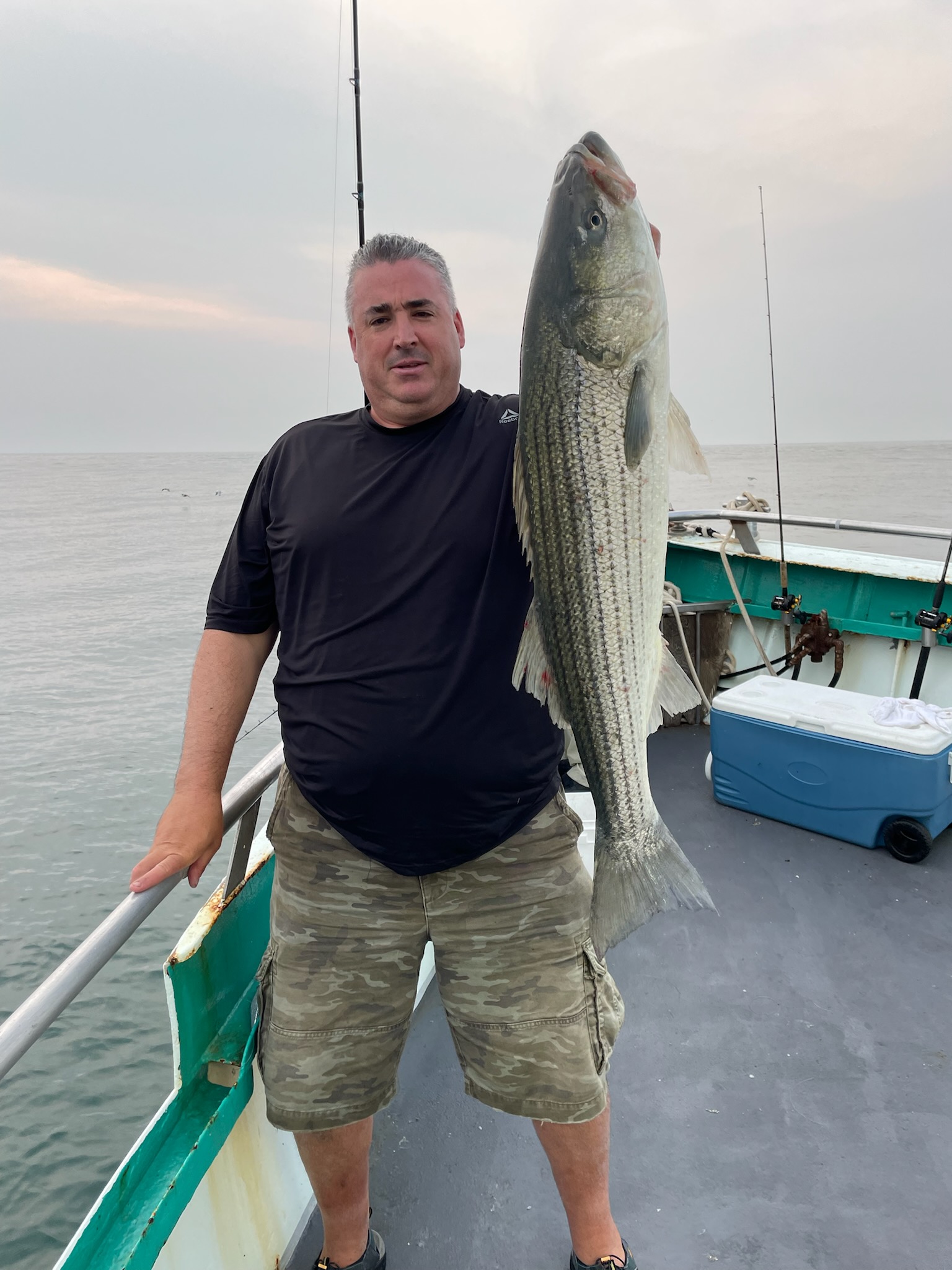 a man holding a fish in the water