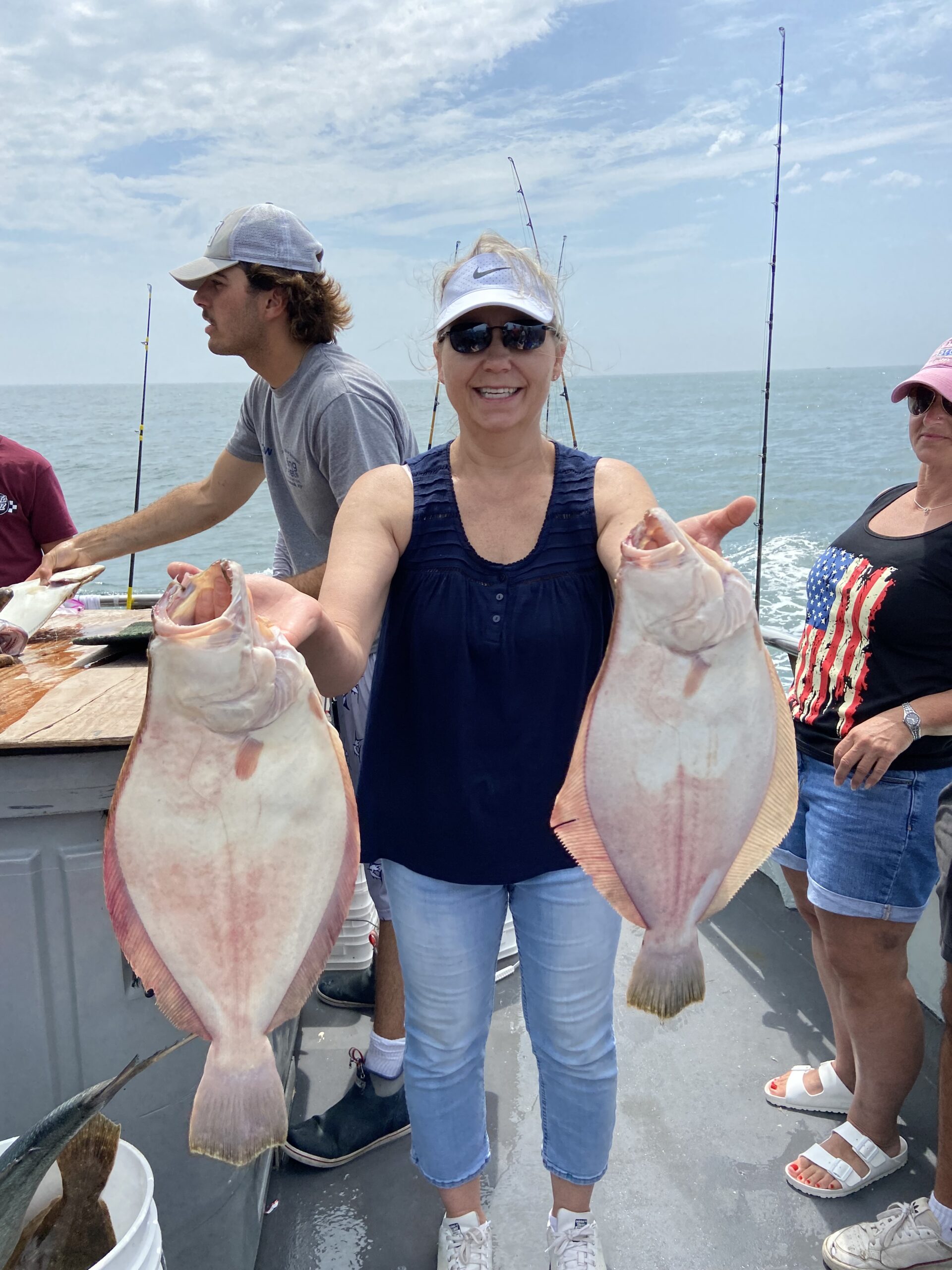 a man and a woman holding a fish in the water