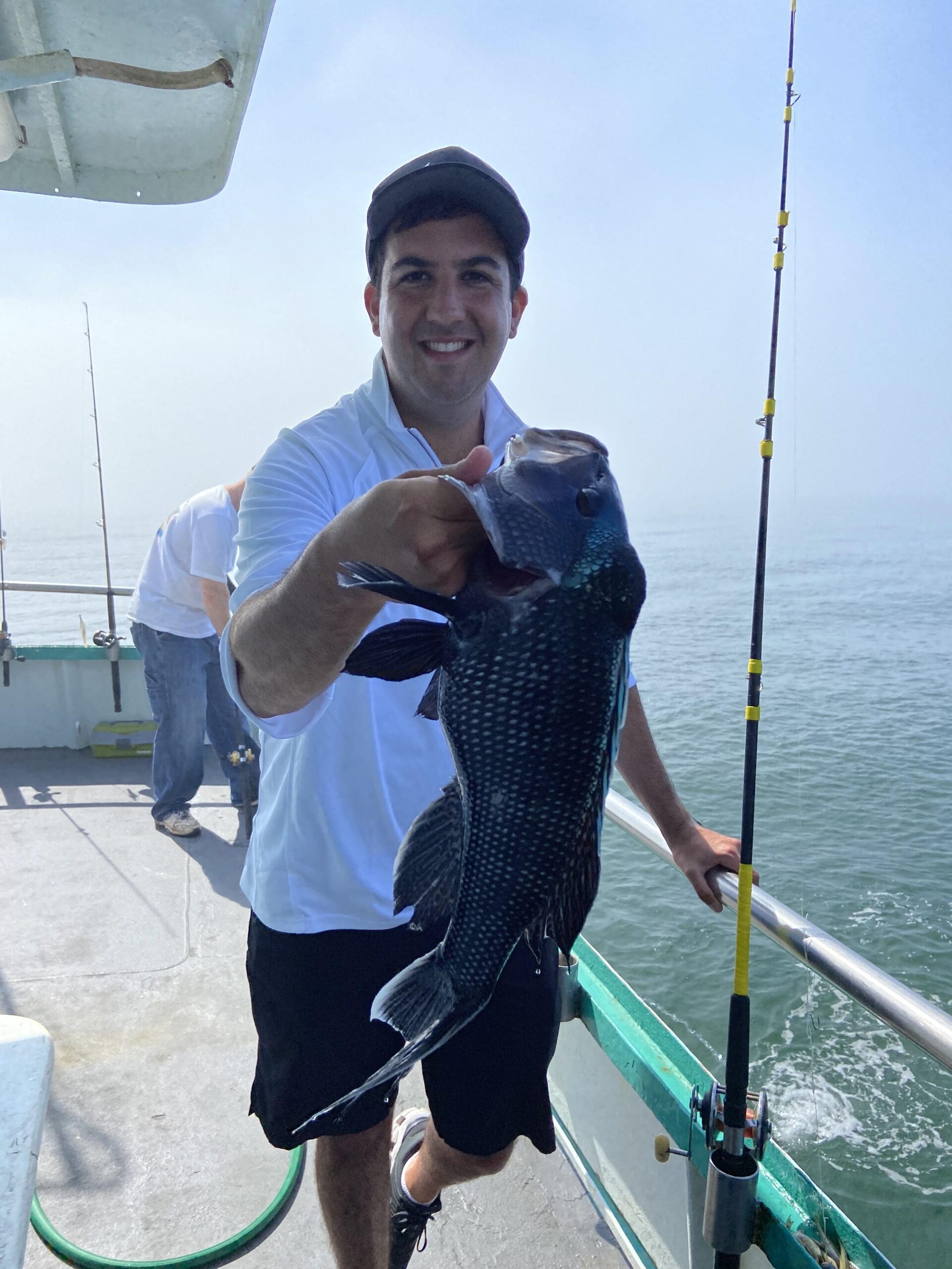 a man holding a kite in a boat on the water