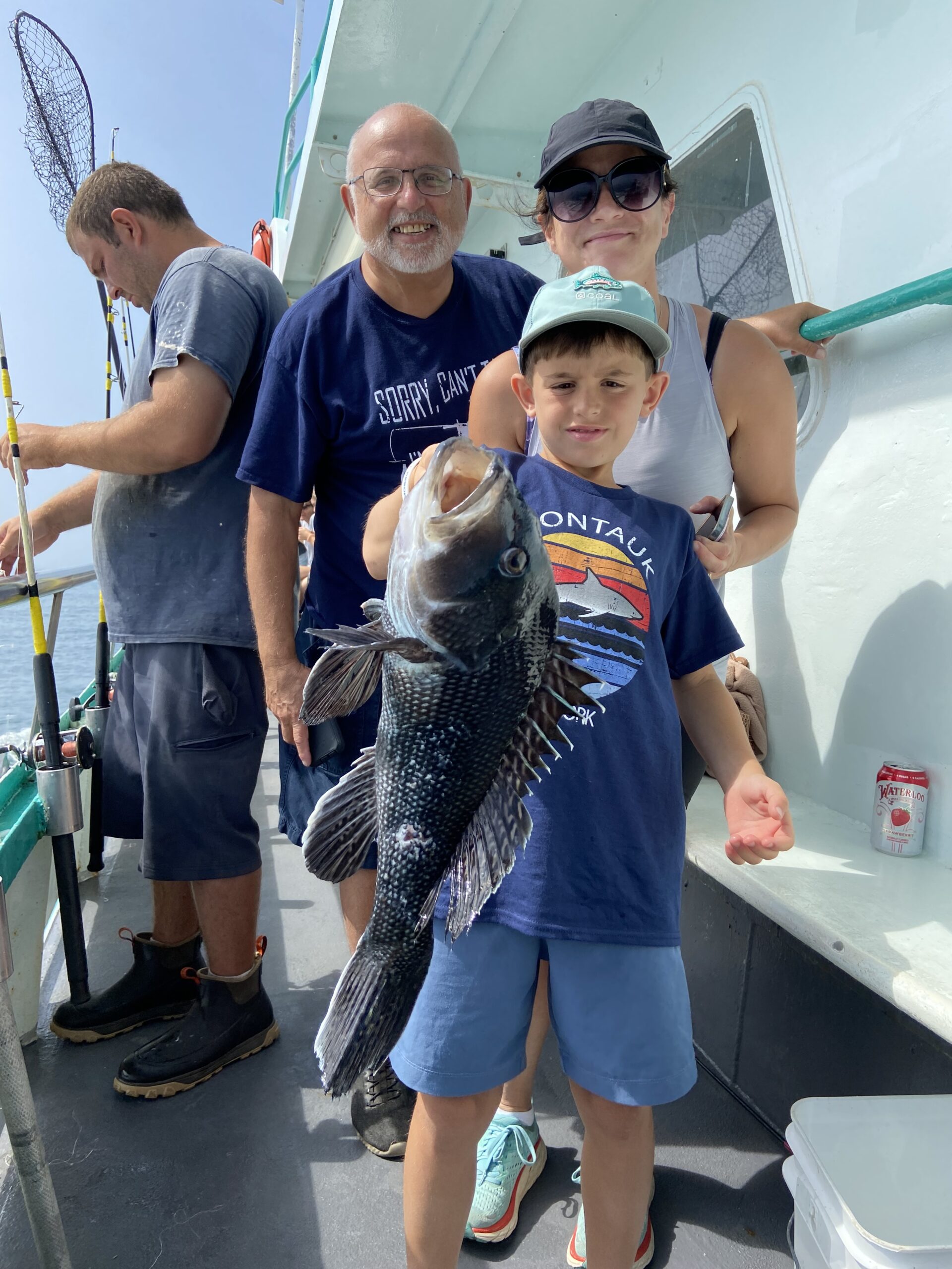 a group of people standing next to a person holding a fish