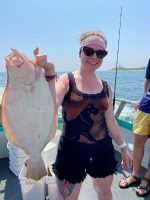 a man and a woman holding a fish
