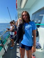 a person standing next to a boat