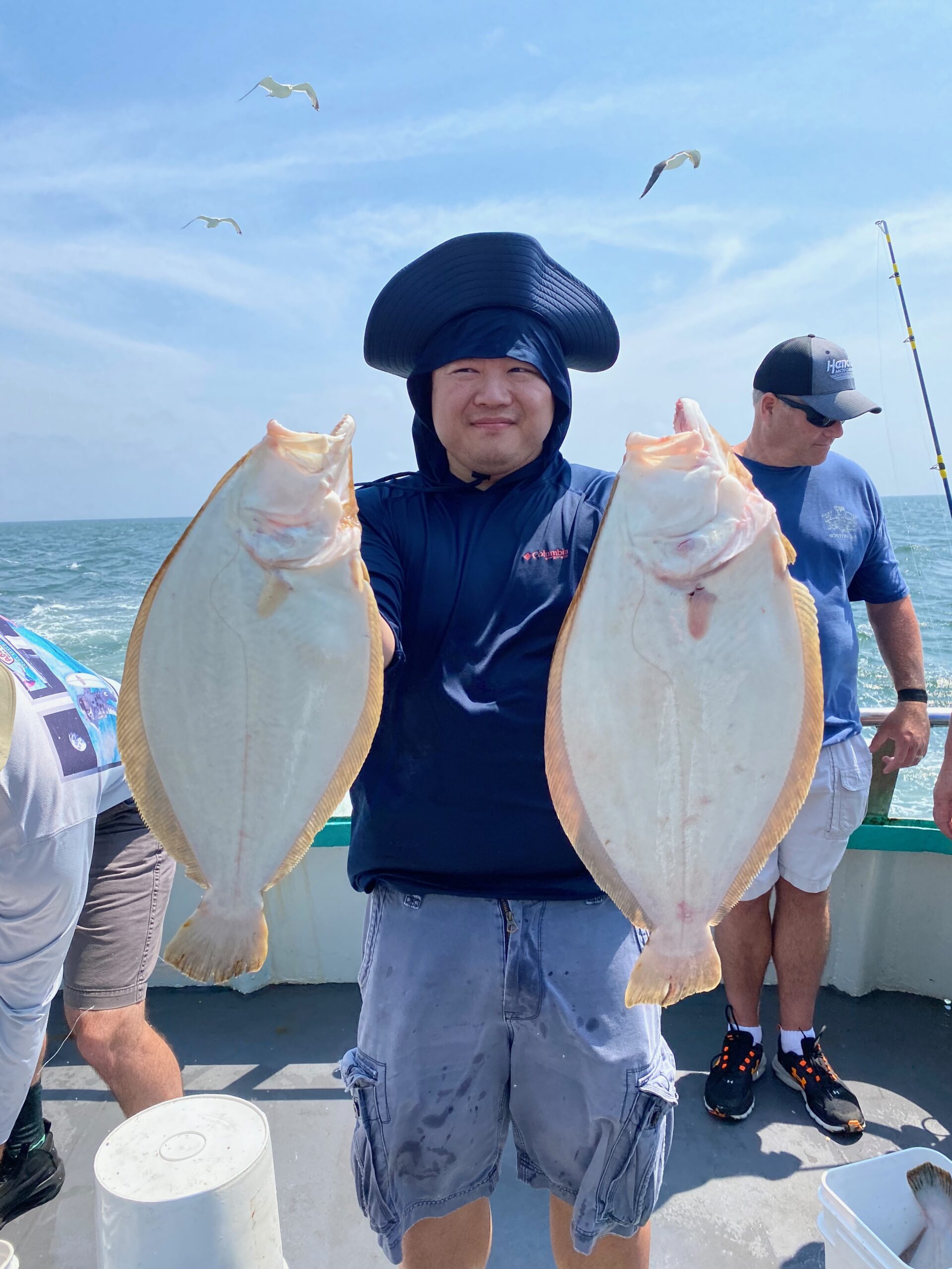 a couple of people that are standing in the ocean