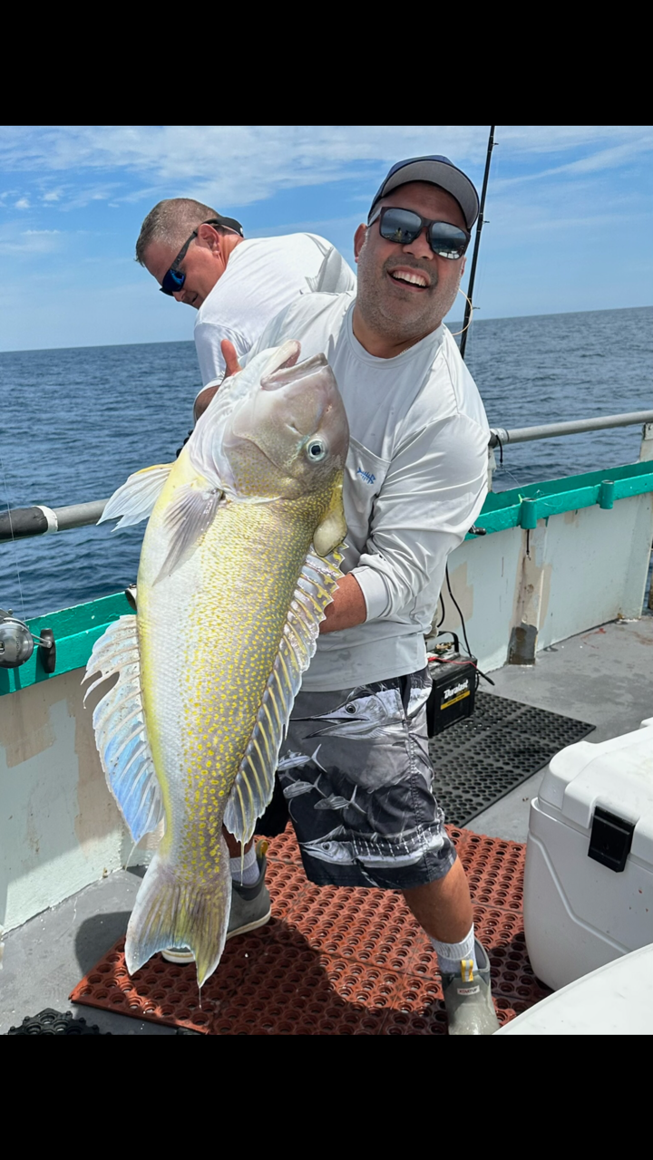 a man holding a fish in the water