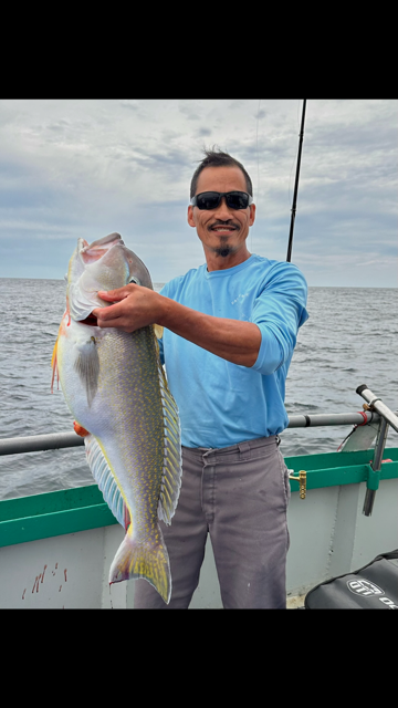 a man holding a fish in the water