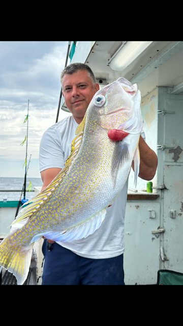 a man holding a fish