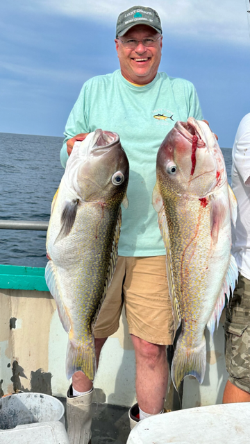 a man holding a fish