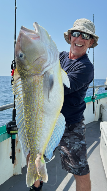 a man holding a fish