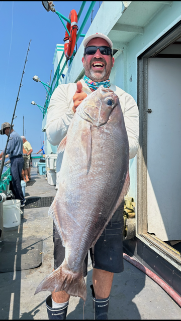 a man holding a fish