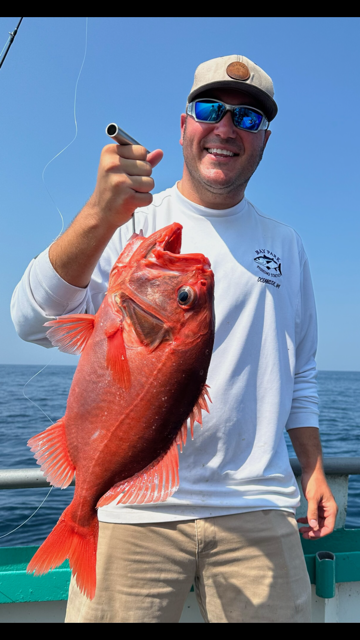 a man holding a fish