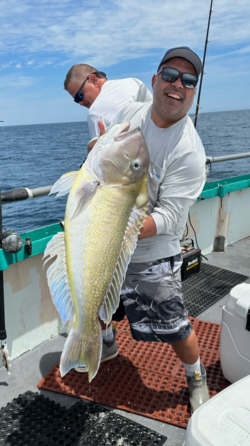 a man holding a fish in the water