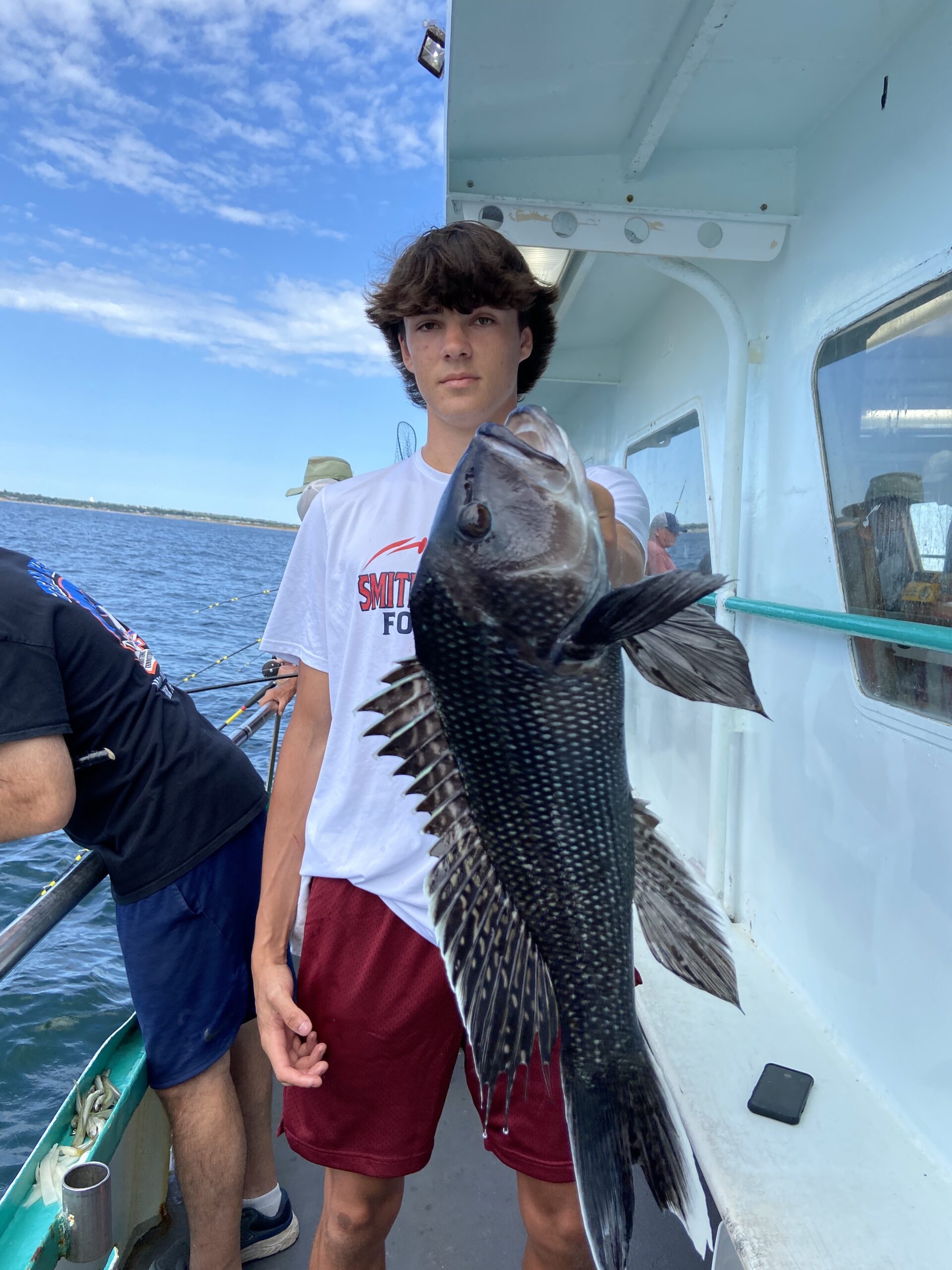 a man holding a fish in the water
