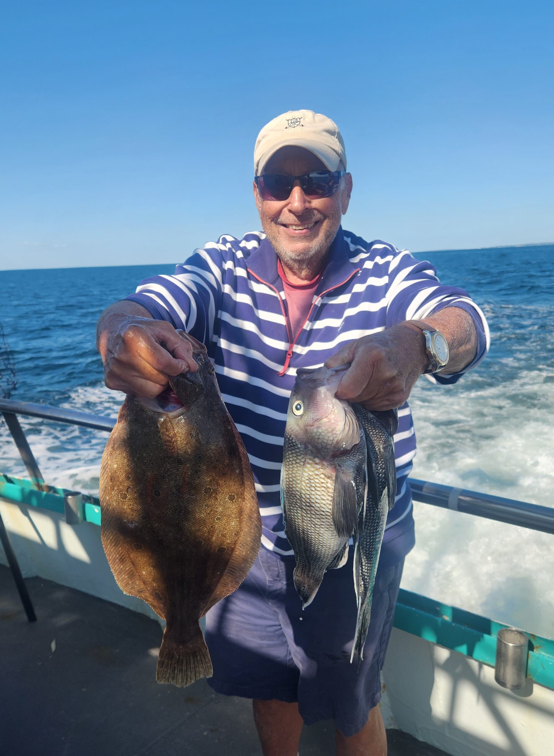 a man holding a fish in the water