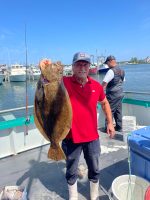a person holding a fish in the water
