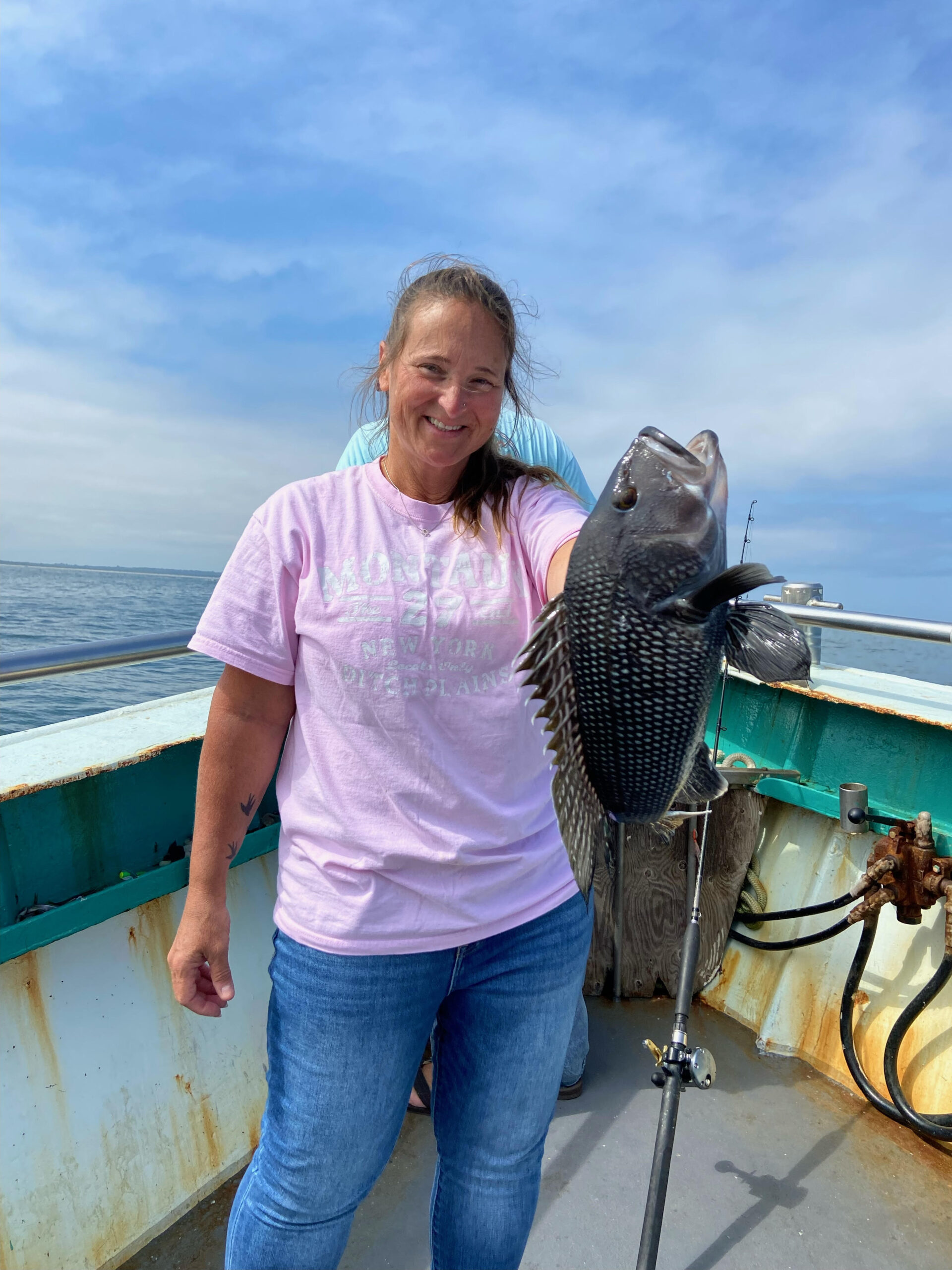 a man holding a fish in the water