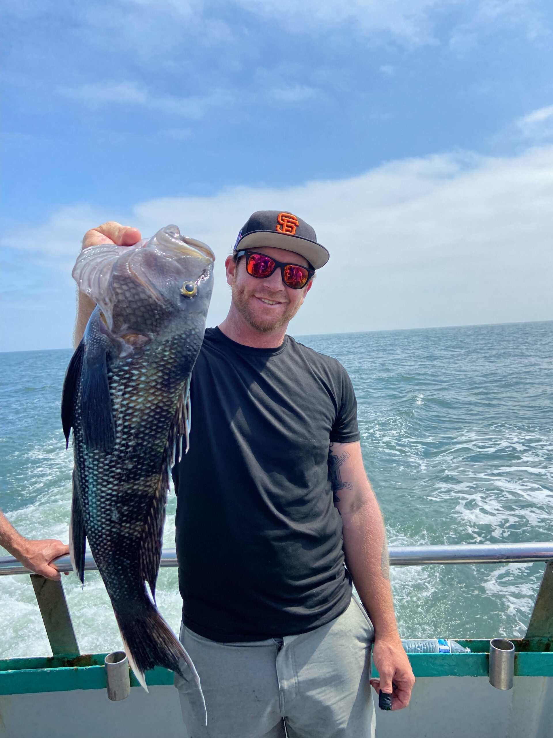 a man holding a fish in the water