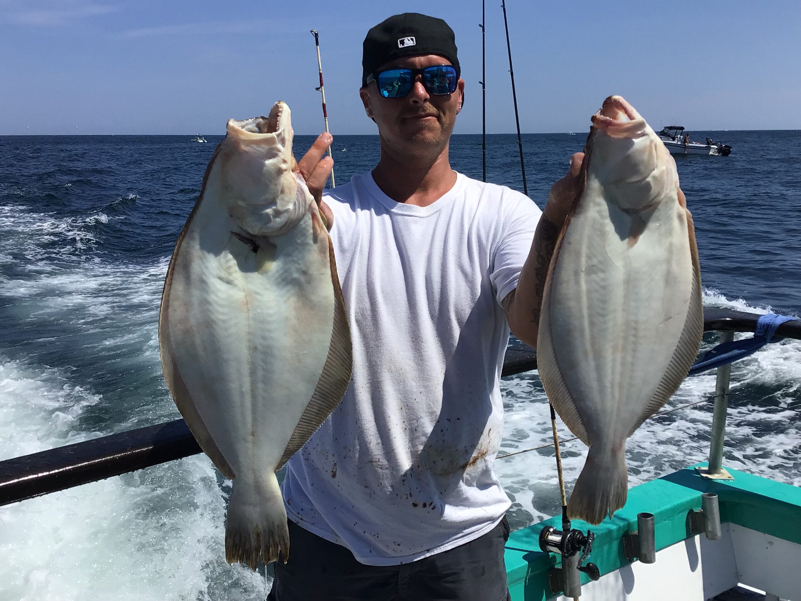a man holding a fish in the water