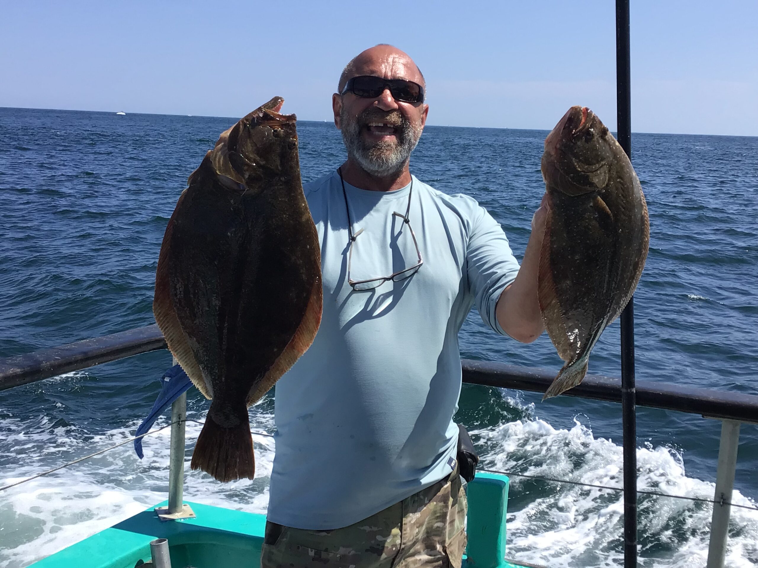 a man holding a fish in the water