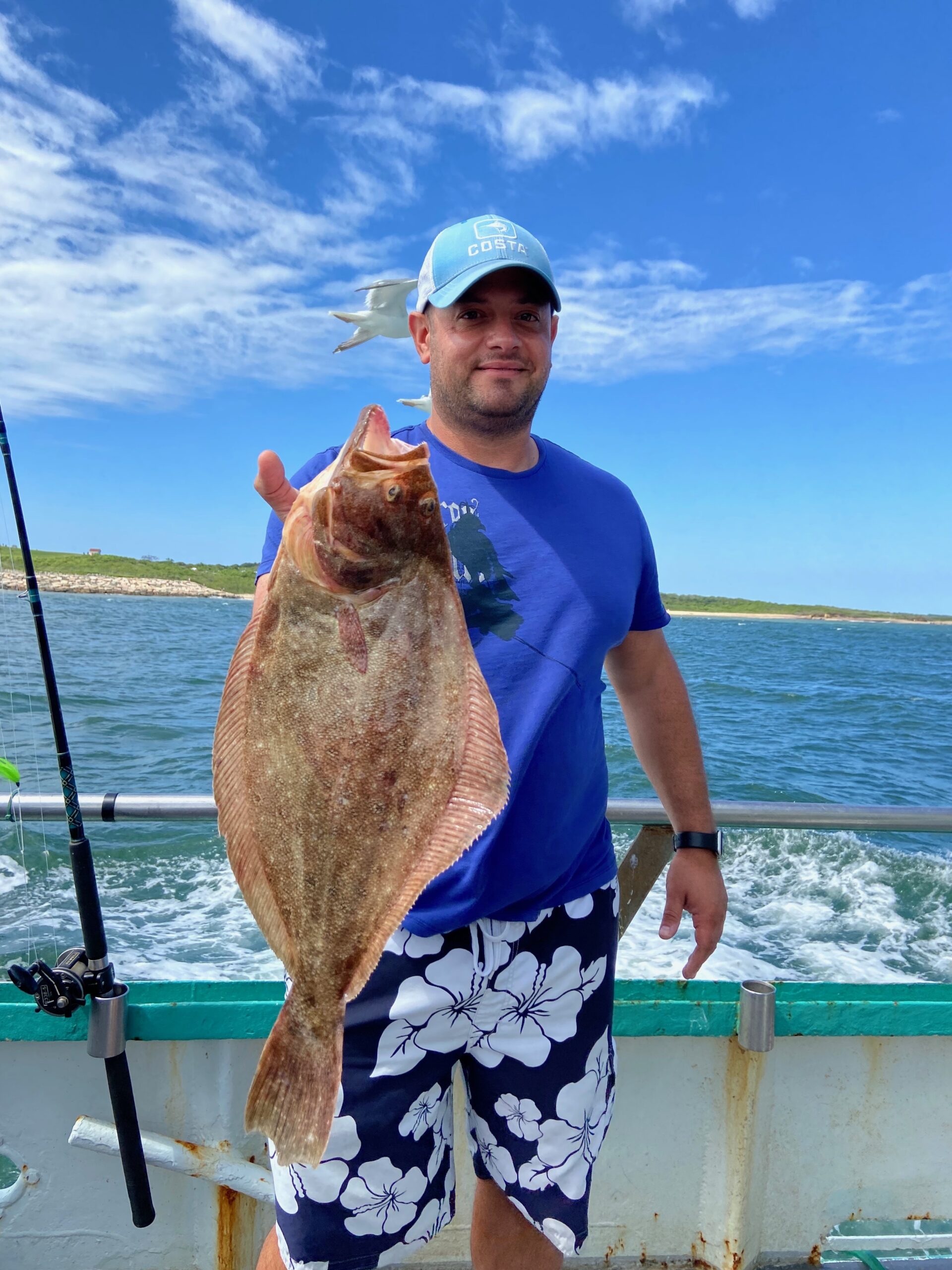 a man holding a fish in the water