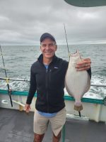 a person holding a fish in the water