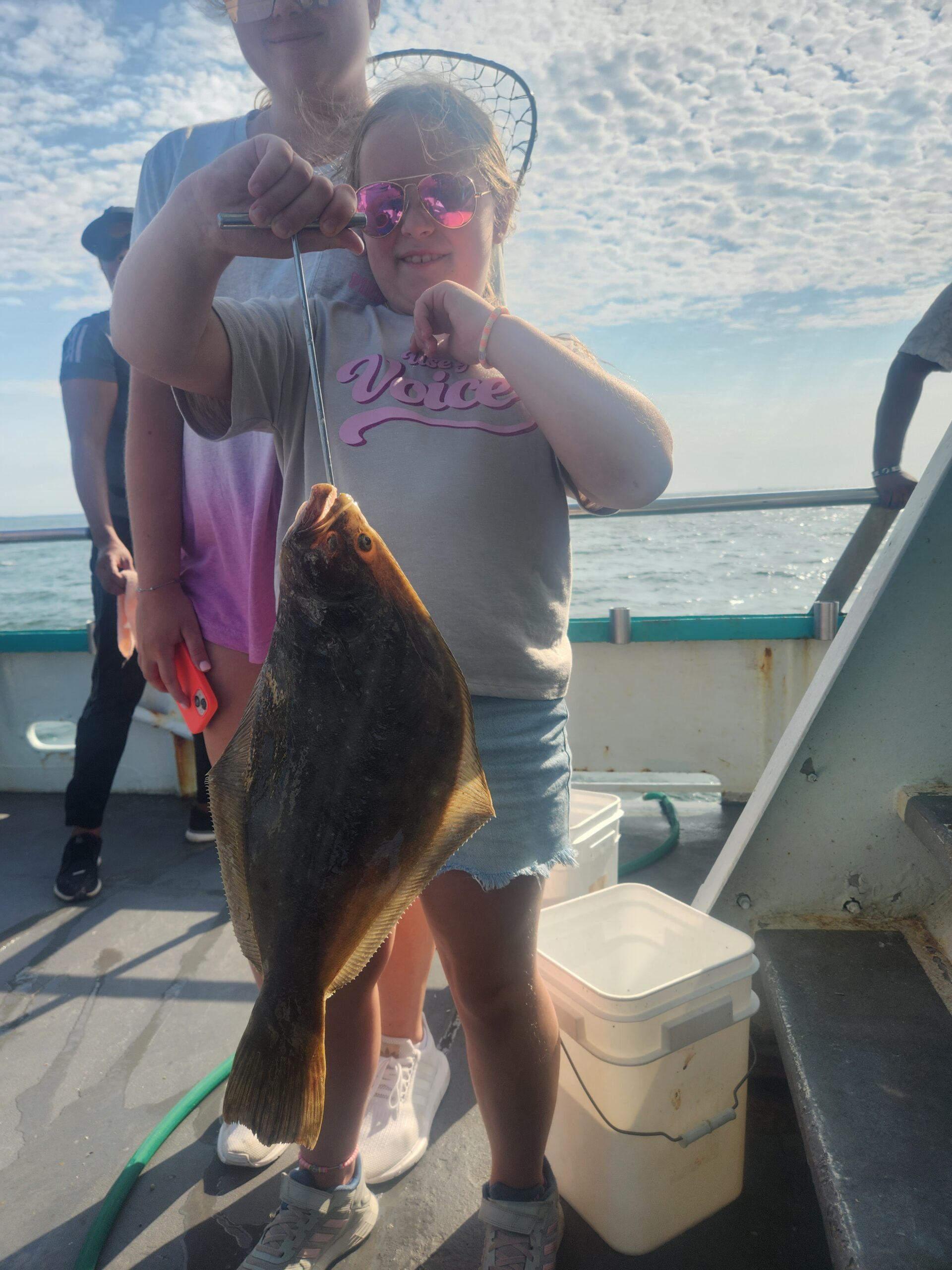 a person holding a fish in the water