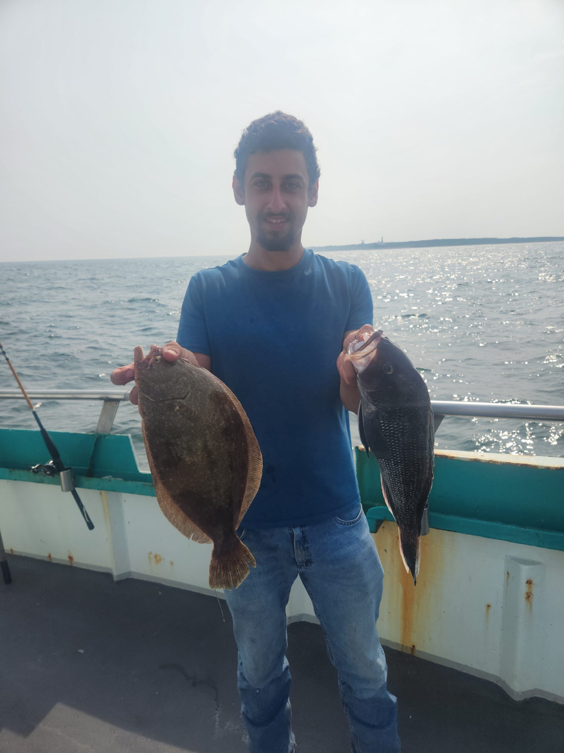 a man standing next to a body of water