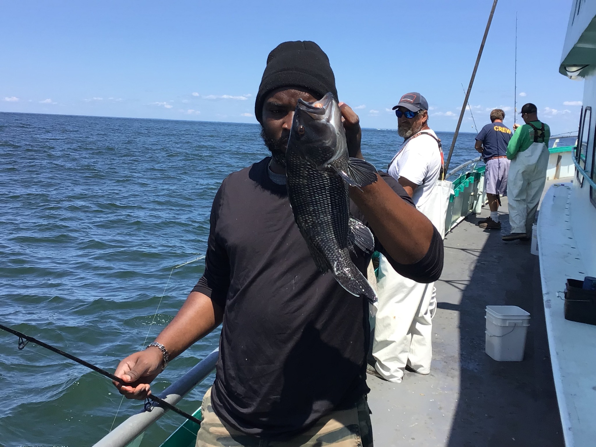 a man standing next to a body of water
