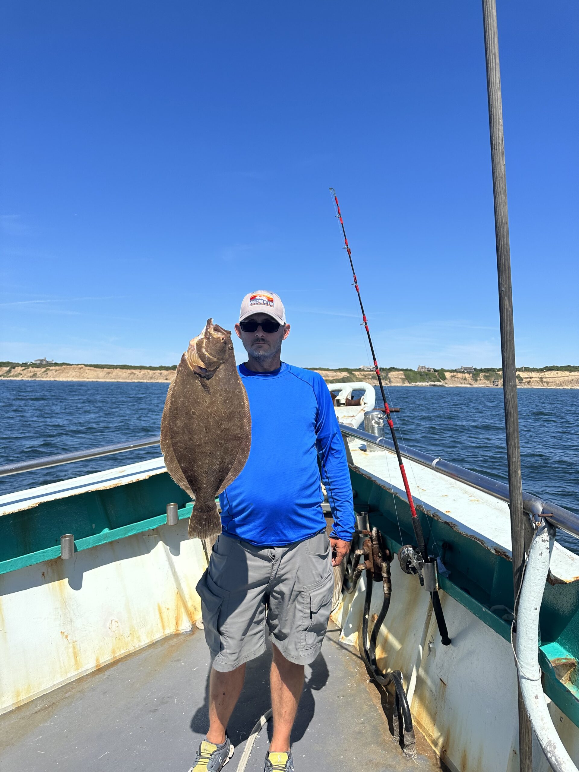 a man standing next to a body of water