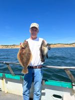 a person holding a fish in the water