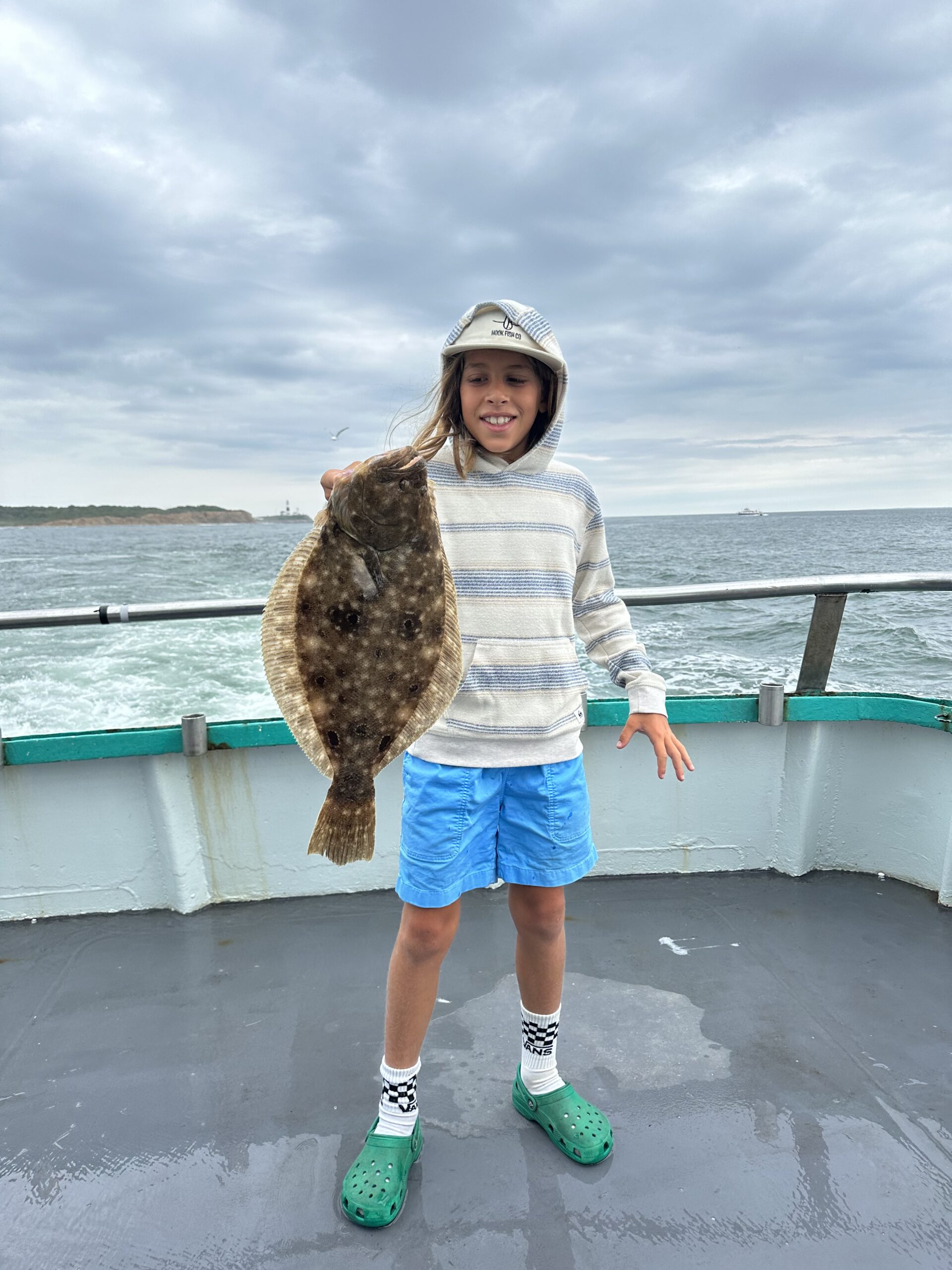 a person standing next to a body of water
