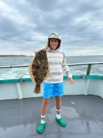 a person standing next to a body of water