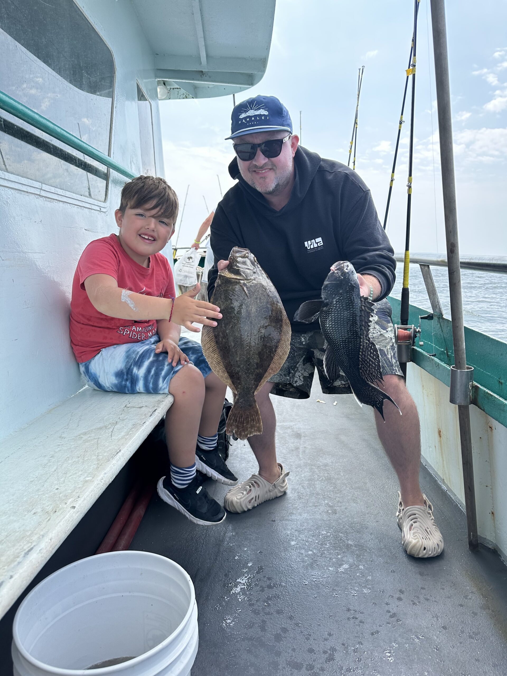a man holding a fish on a boat
