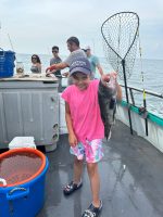 a little girl that is standing in the water