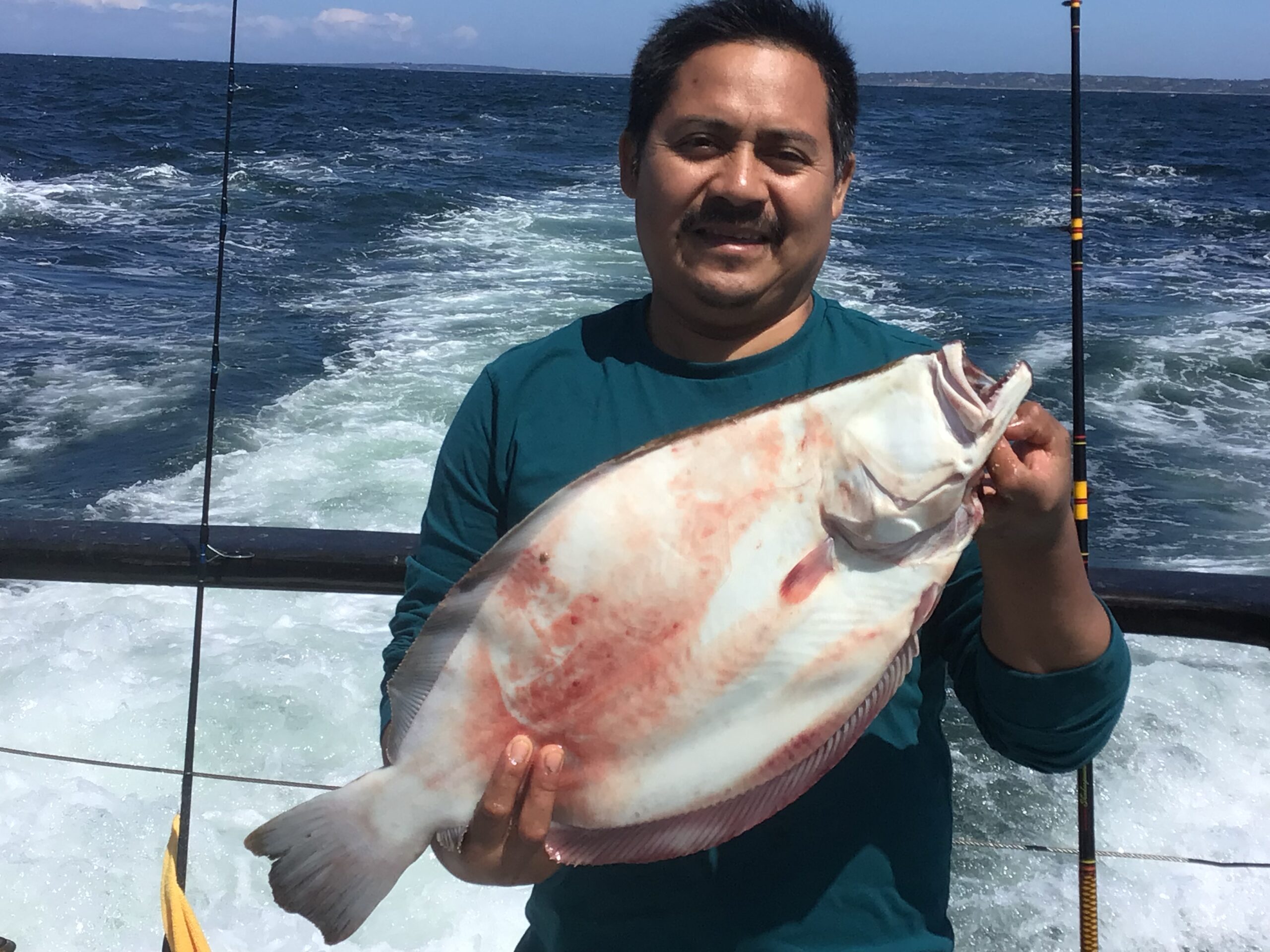 a man holding a fish in the water