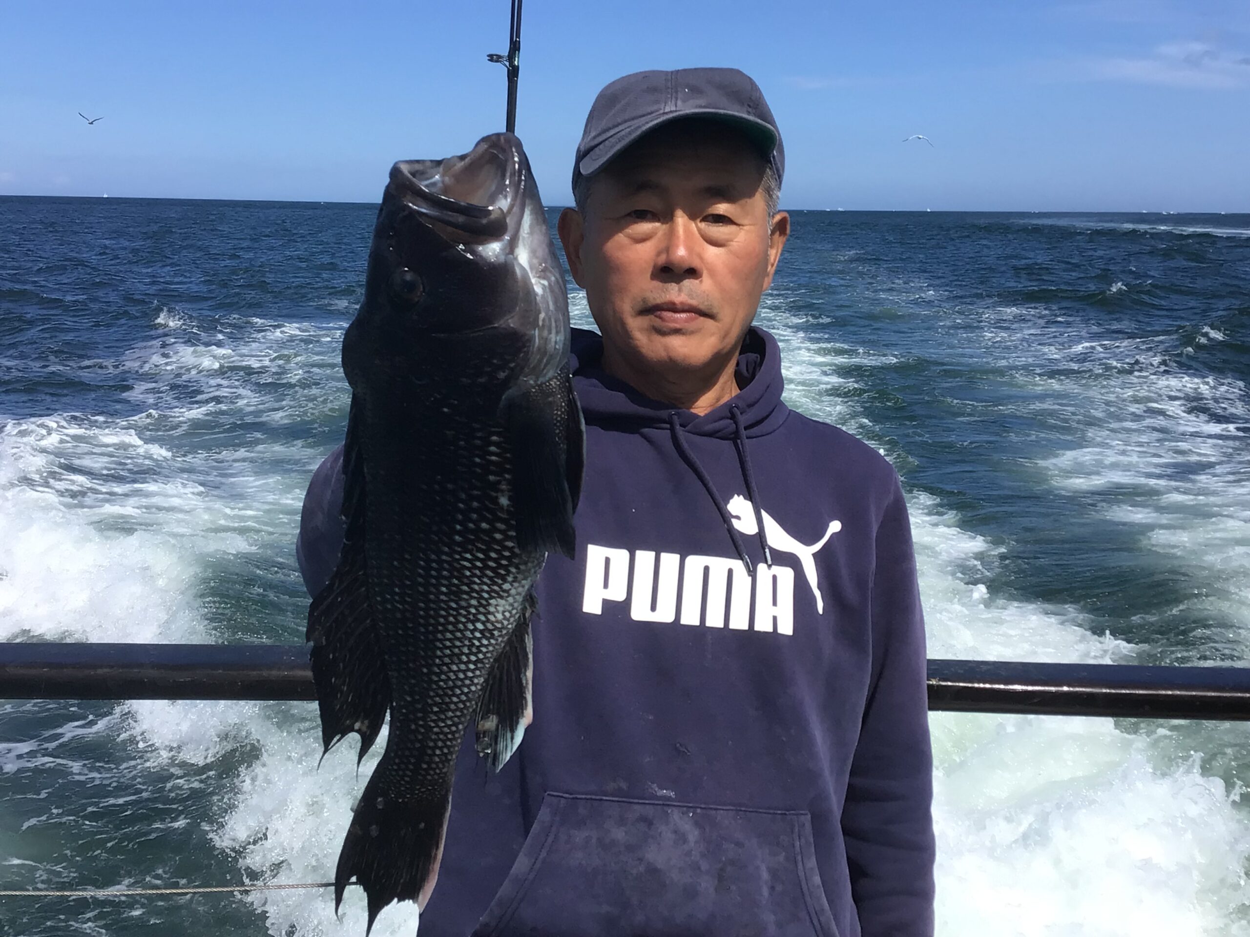 a man holding a fish in the water