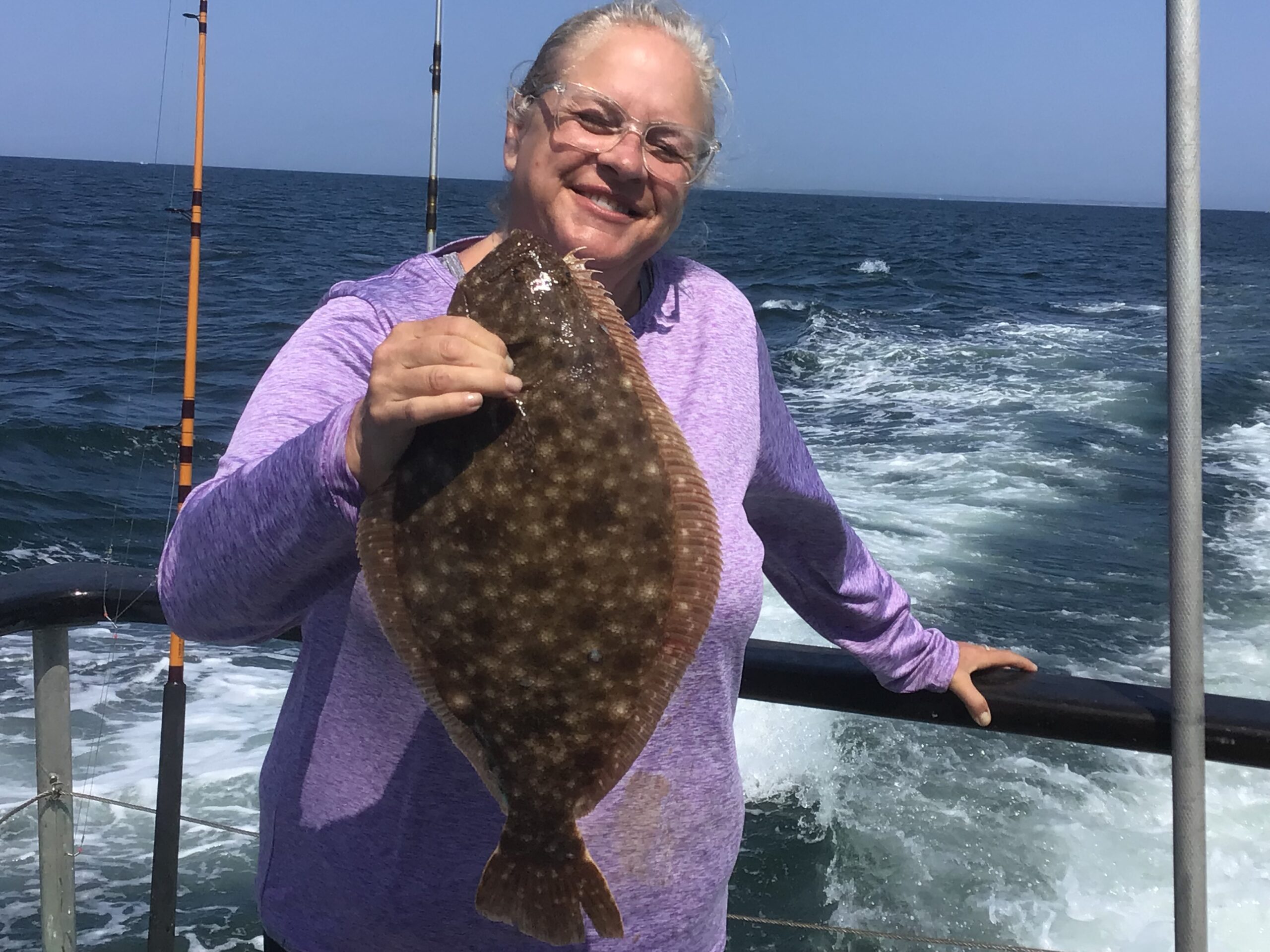 a person standing next to a body of water