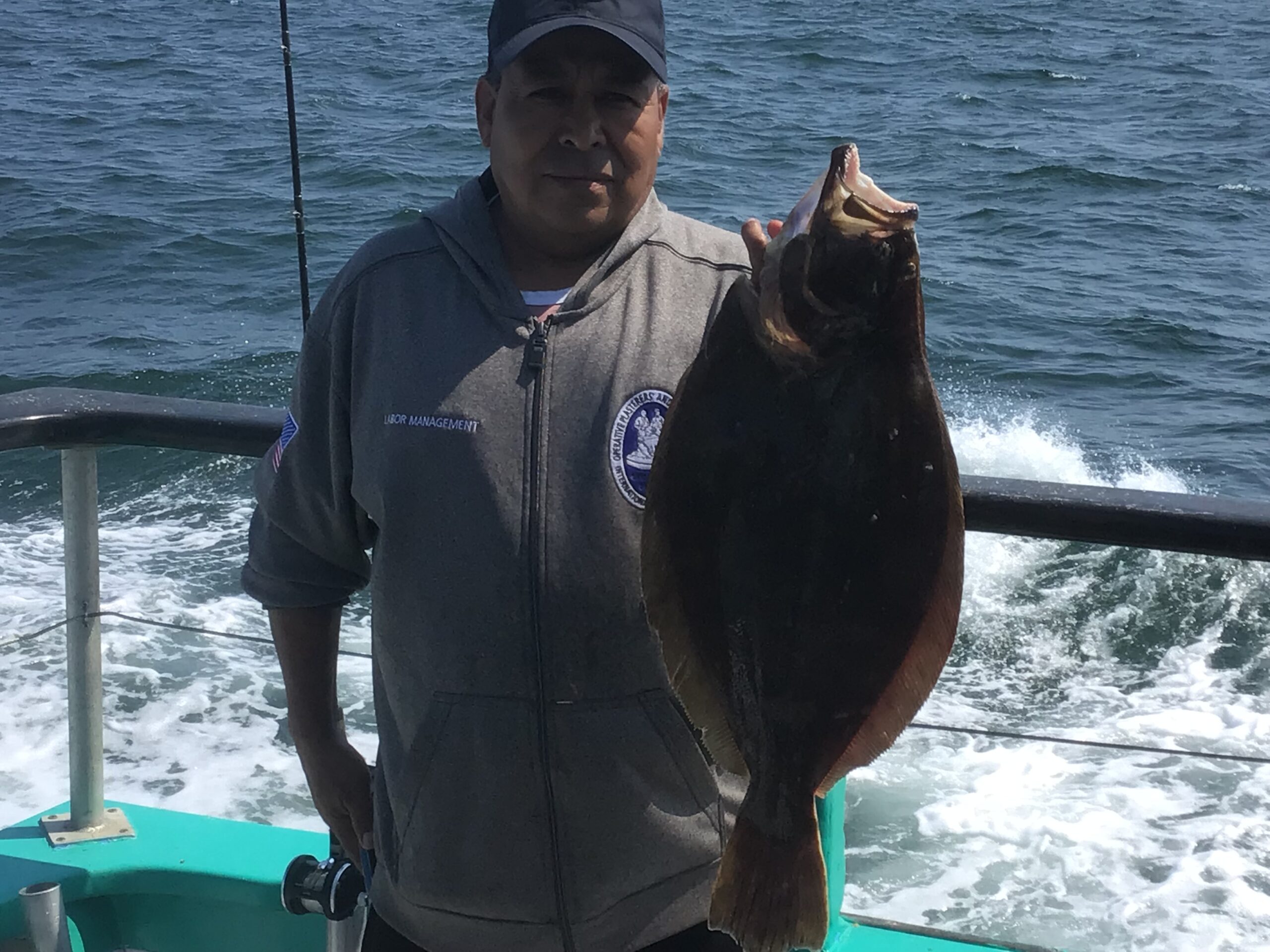 a man holding a fish in the water