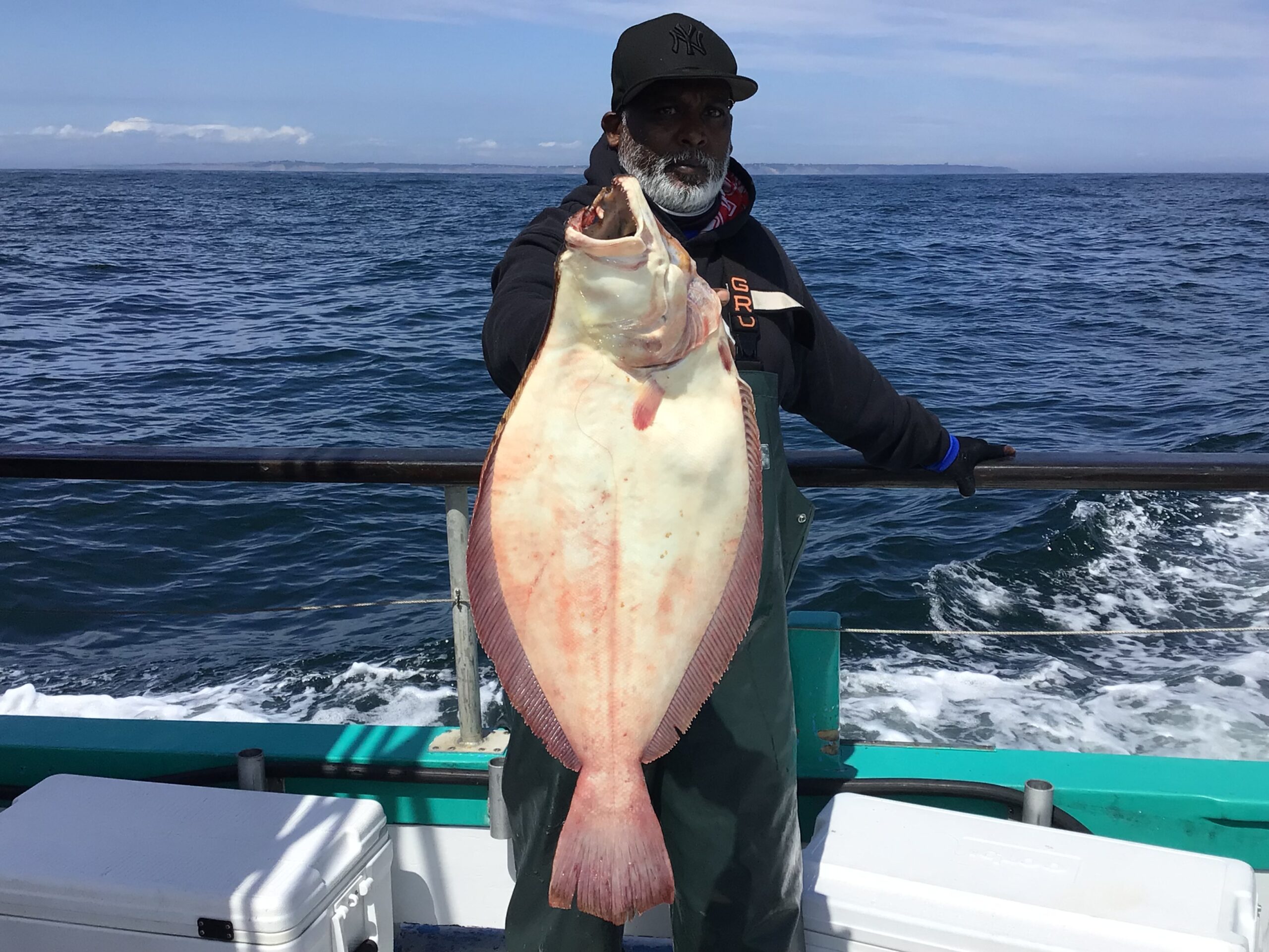 a person holding a fish in the water