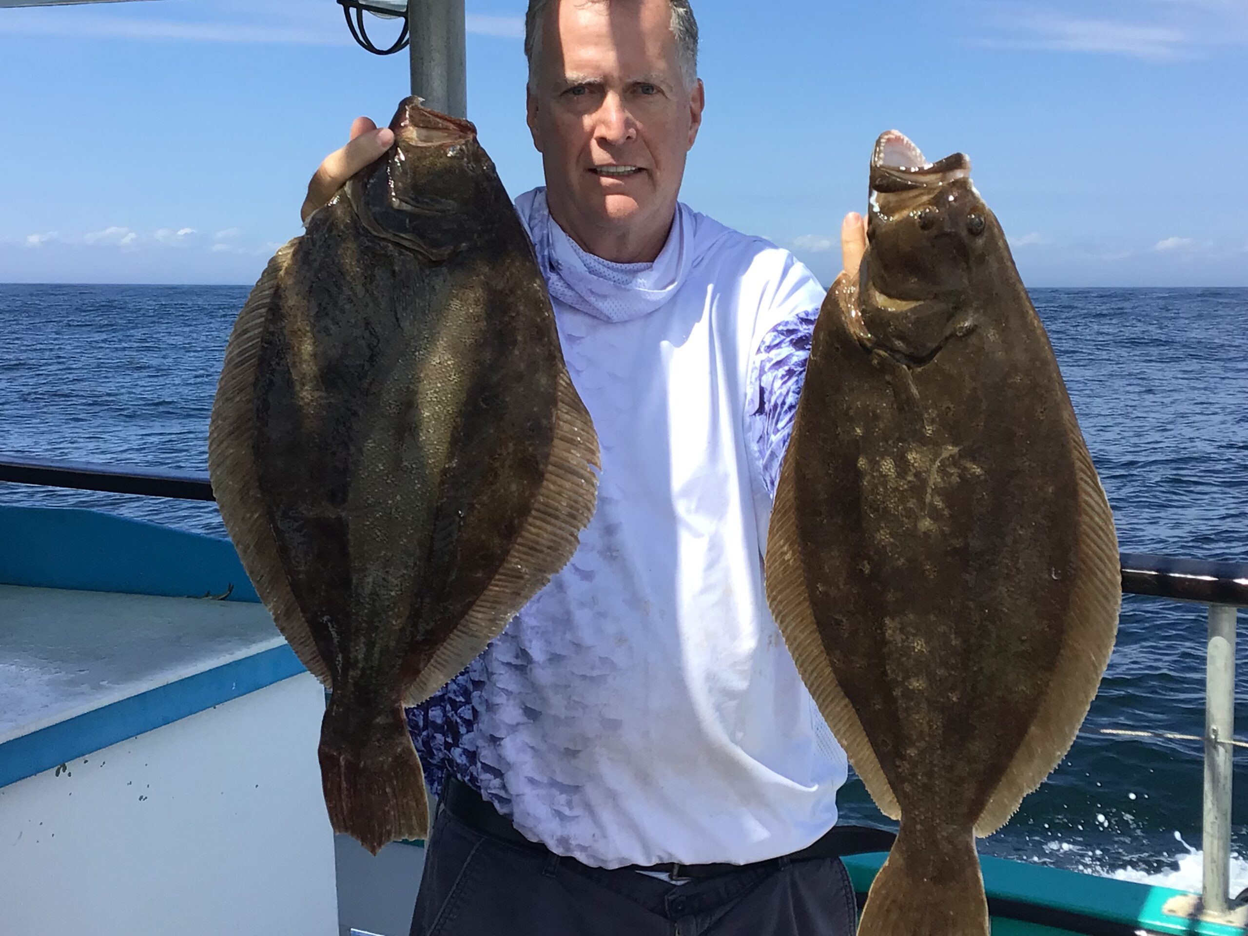 a person holding a fish in the water