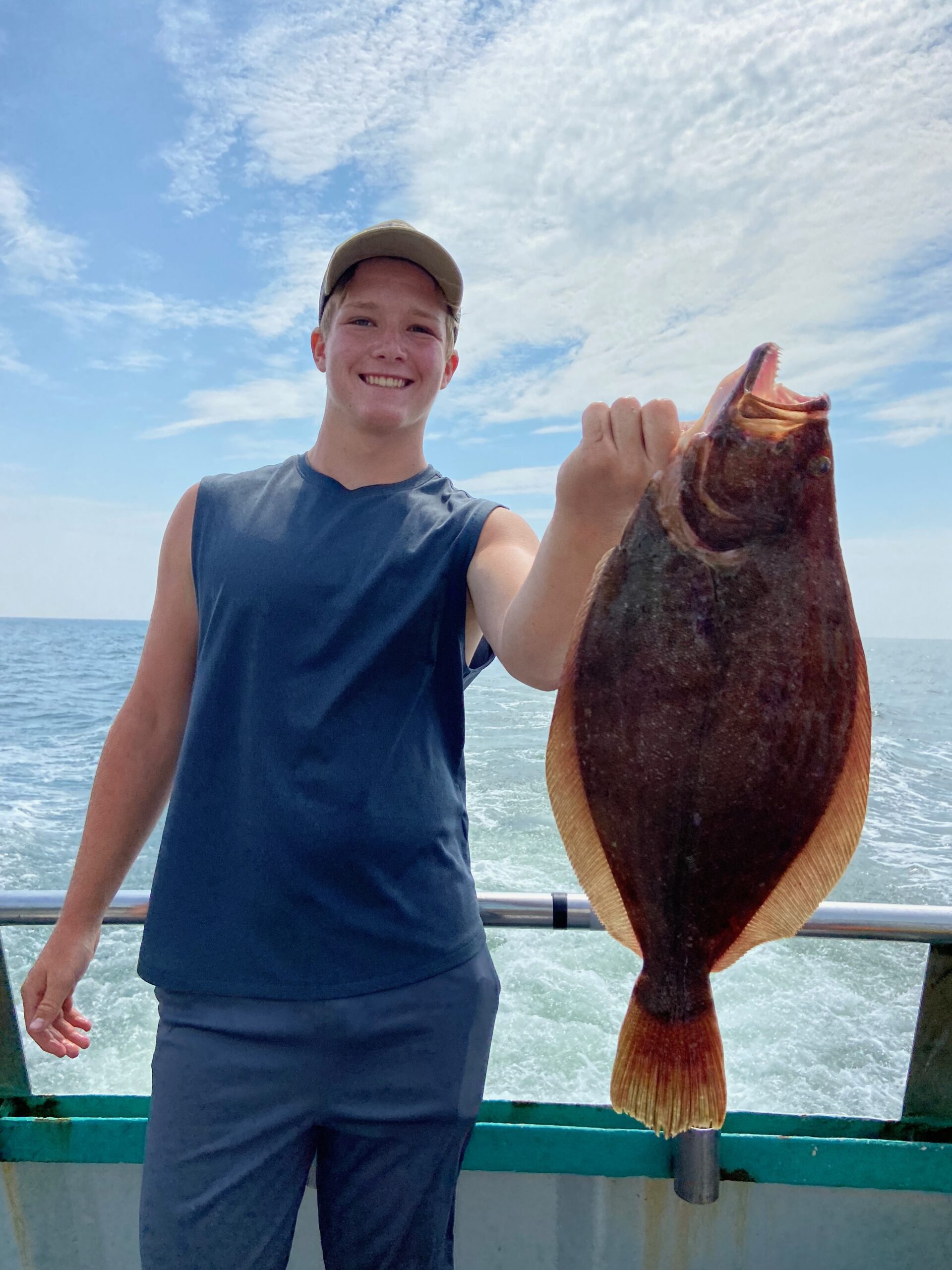 a person holding a fish in the water