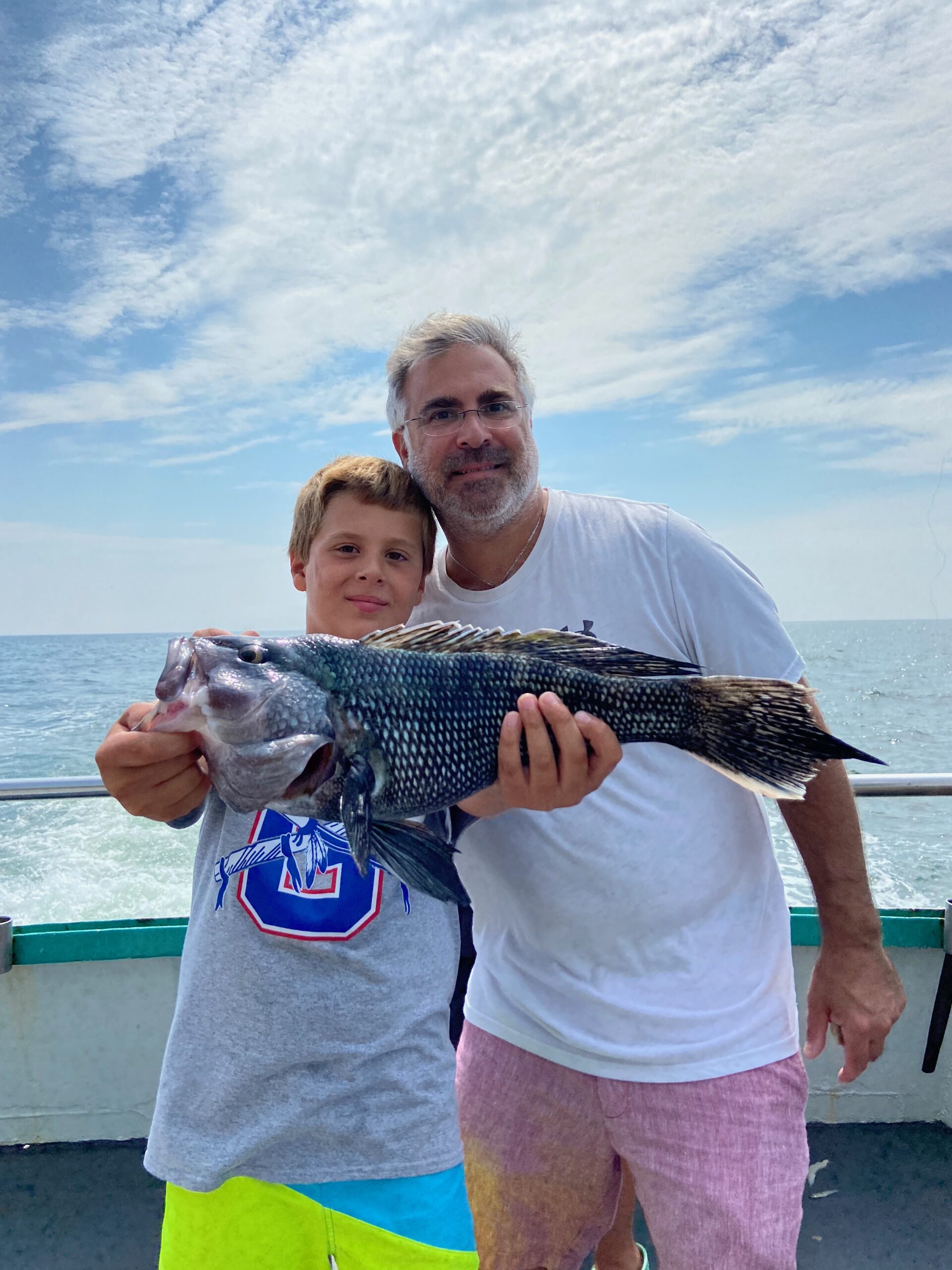 a man holding a baby in a body of water