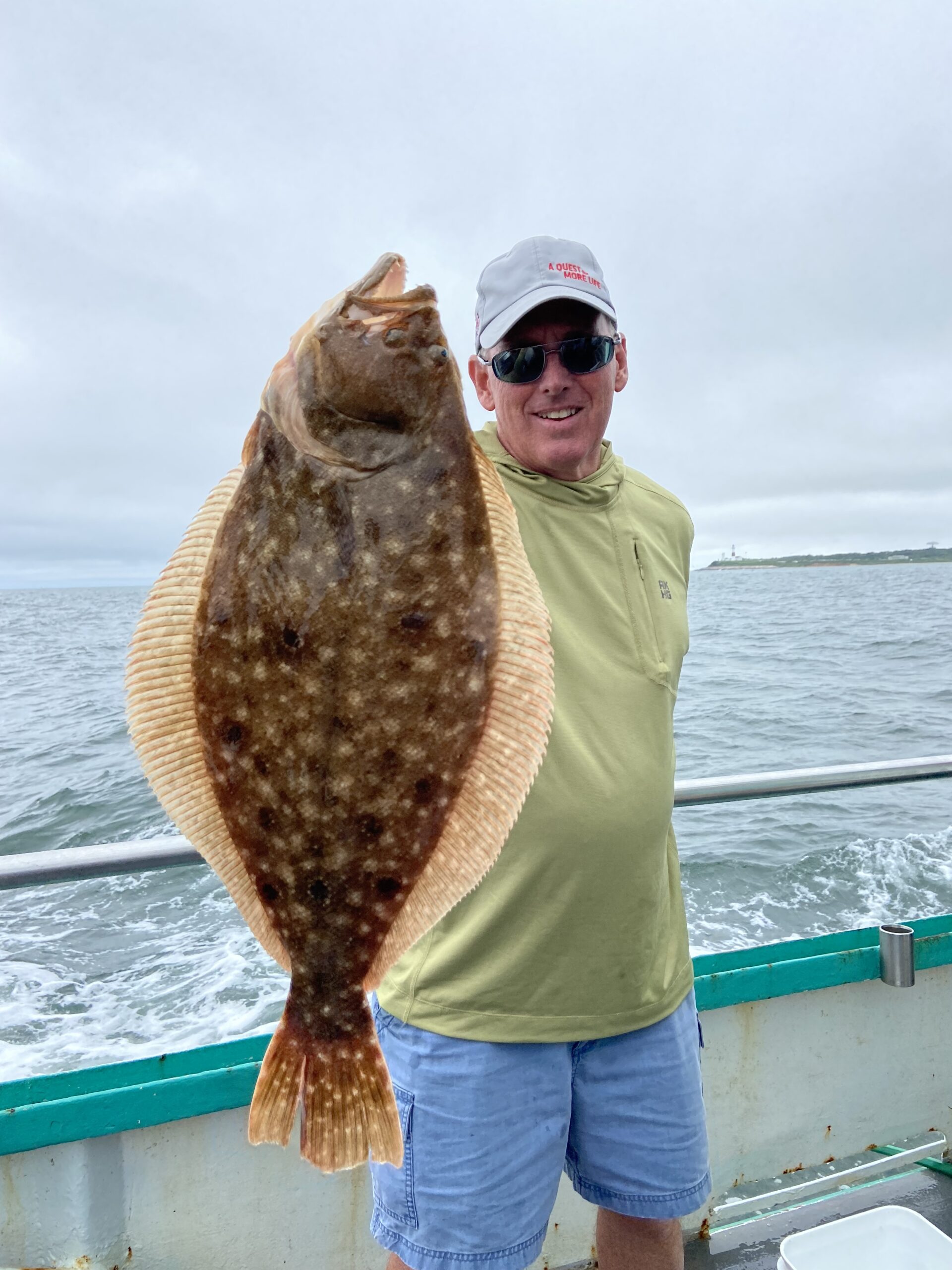 a man holding a fish in the water