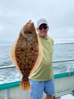 a man holding a fish in the water