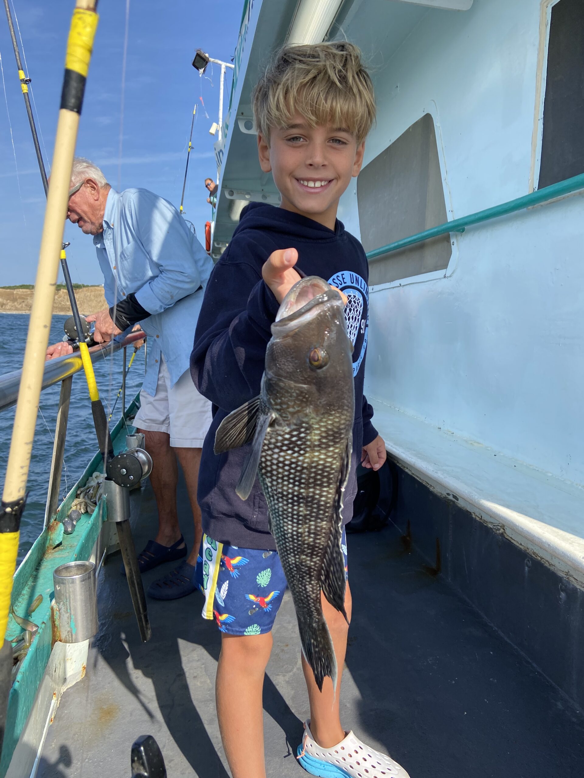 a young boy holding a fish