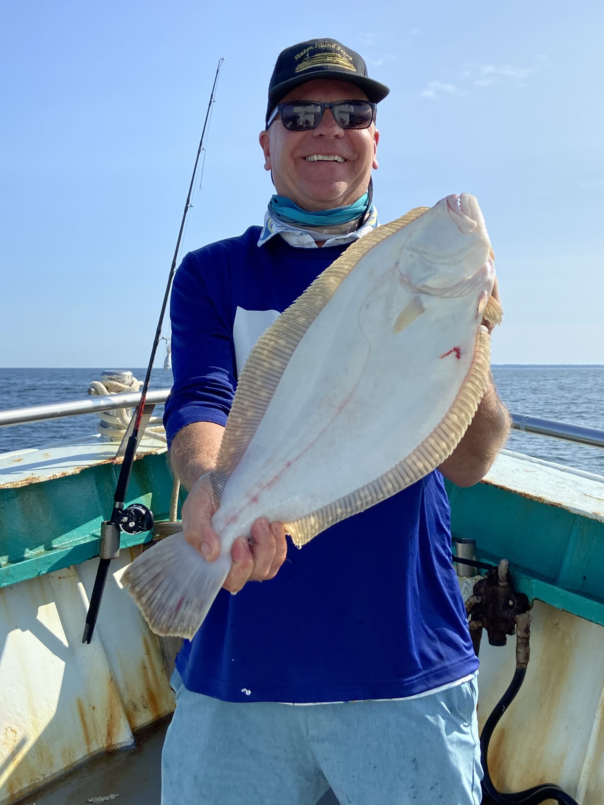 a person holding a fish in the water