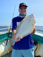 a person holding a fish in the water