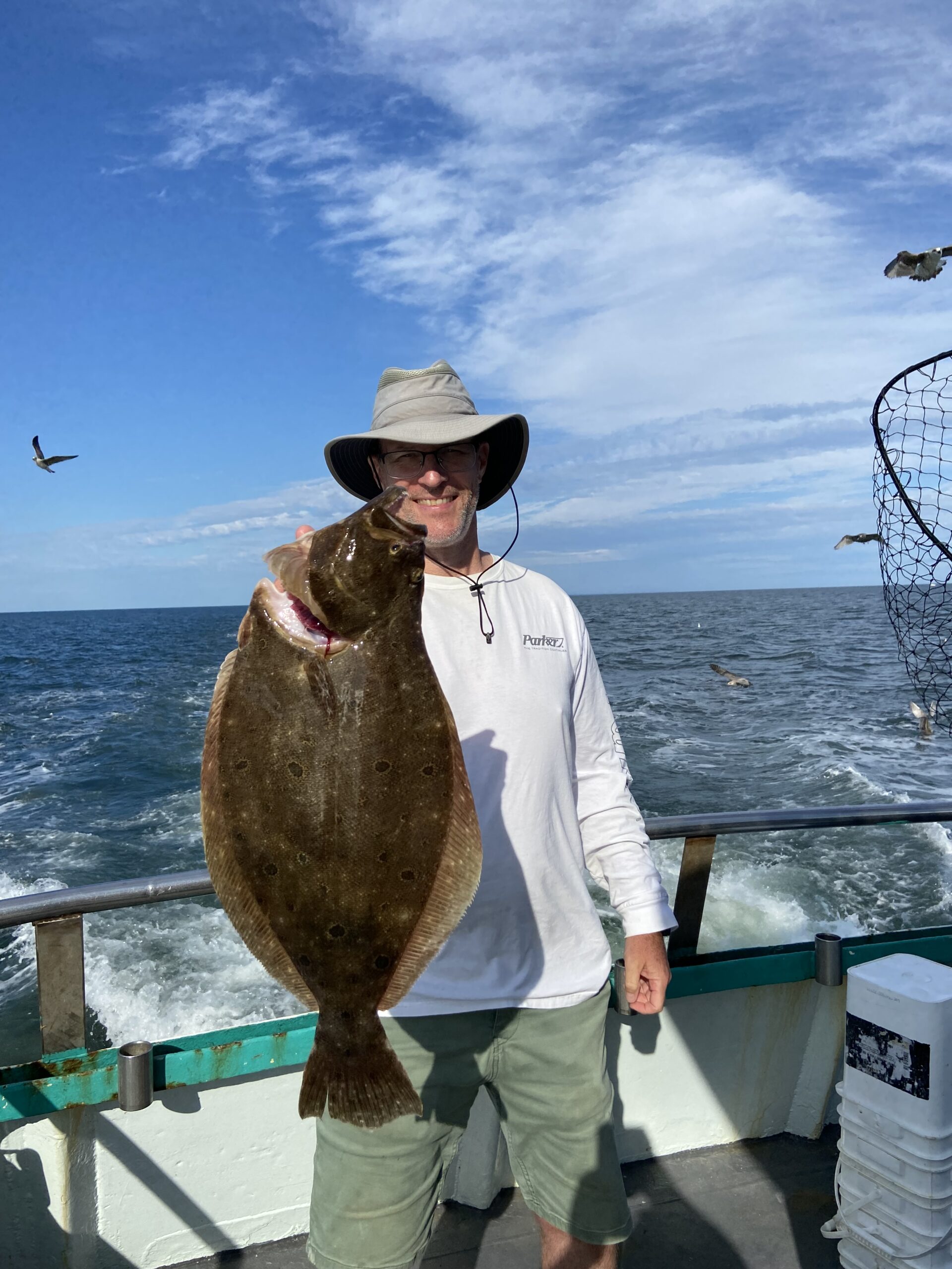 a man holding a fish in the water
